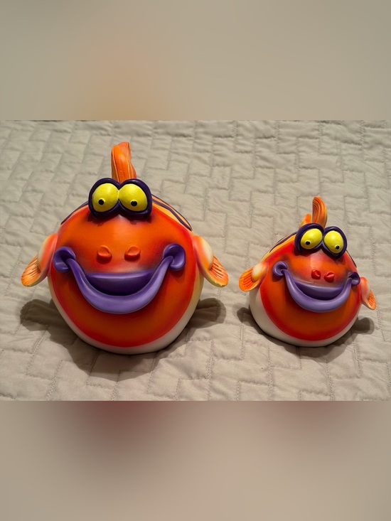 Other - Two purple, yellow and orange ceramic fish-shaped piggy banks.